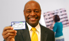 Rev Evans displaying drug card at pharmacy
